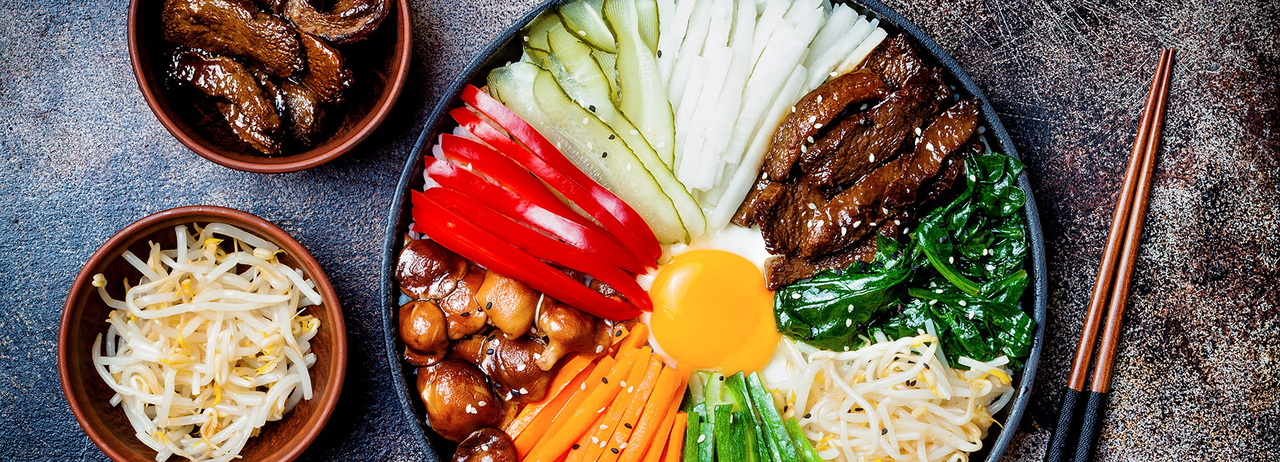 a plate of Bibimbap, a traditional Korean dish of rice with vegetables and beef